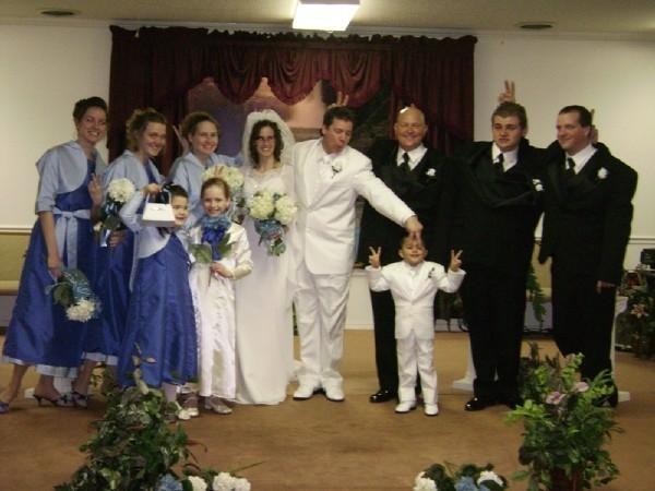The groom and ring bearer wore all white tuxedos It was like mini me