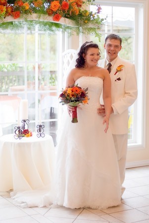 The arch was created with a swag of curly willow These wedding flowers were