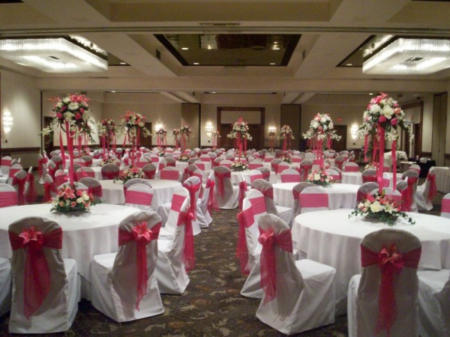 Fuschia wedding reception complete with ceiling decoration chair covers 