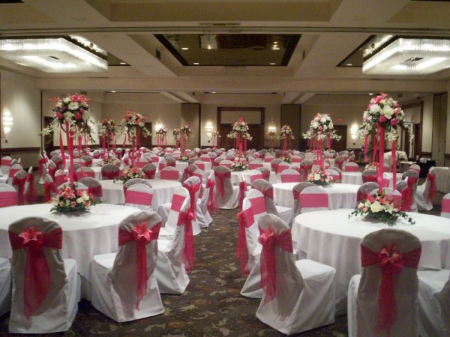 Fuschia wedding reception complete with ceiling decoration chair covers