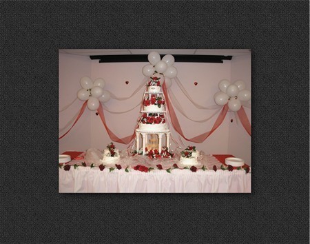  adorning the three tier fountain wedding cake with romantic red roses