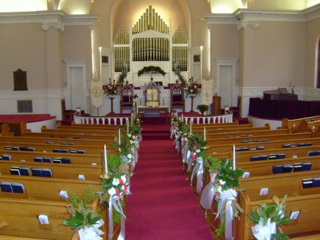  floral arrangements and ornate floral pew candle globes 