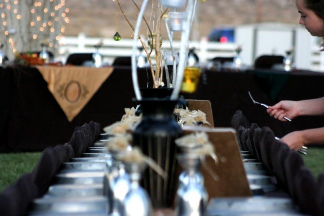 This lovely wedding reception features black tablecloths and chair covers 