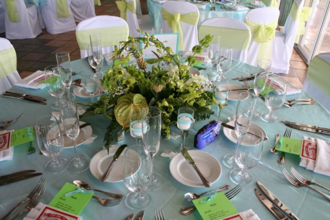 This wedding reception is decorated in light green and white with a pastel