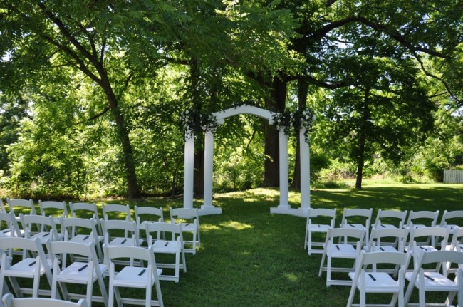 Solid white wedding arches and matching columns are beautiful for outdoor 