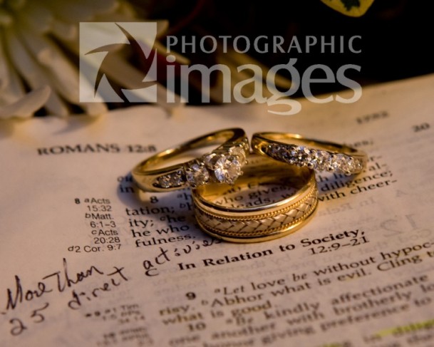 Here the wedding rings and engagement ring are placed on the Holy Bible 