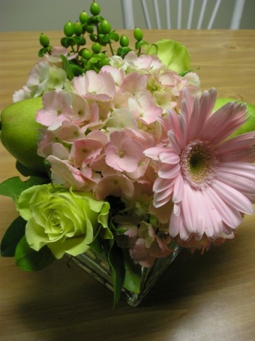 This floral centerpiece was designed for a wedding reception and consists of