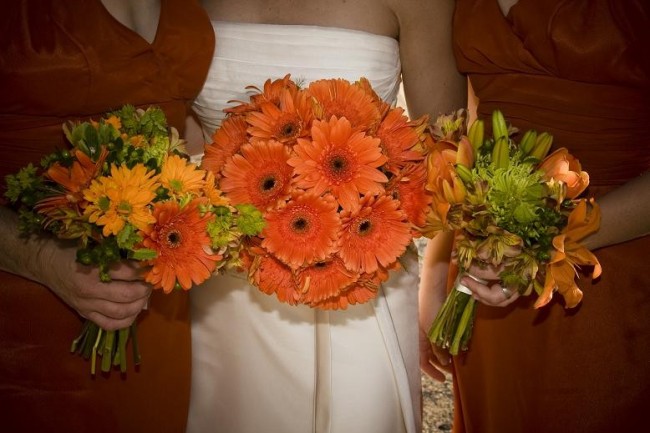 The nosegay bridal bouquet in the center consists entirely of orange gerbera