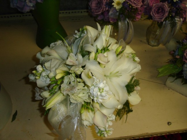 This all white bridal bouquet was created using a mix of white lilies 