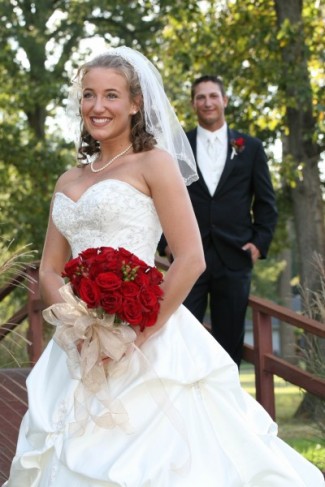 The bride's striking red rose wedding bouquet is an eyecatching sight but