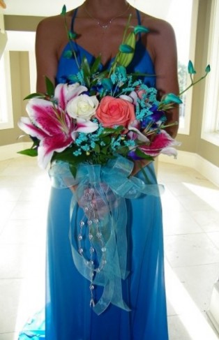 using many bright beautiful flowers such as stargazer lilies and roses