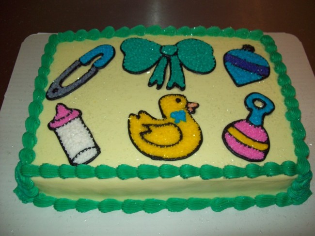 This neat baby shower cake is decorated in pale yellow icing with green