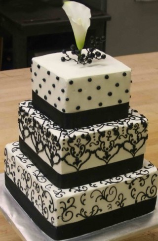 This is a beautiful elegant black and white wedding cake featuring three 