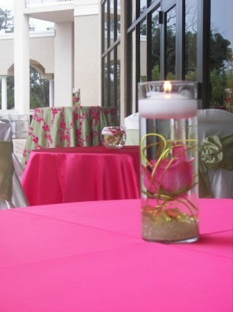 These beautiful centerpieces with floating pink roses and tea light candles 