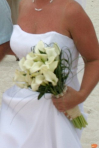 This bride chose a beautiful white calla lily bridal bouquet for her beach 