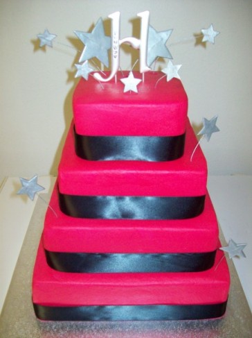 This is a hot pink buttercream wedding cake with airbrushed silver stars