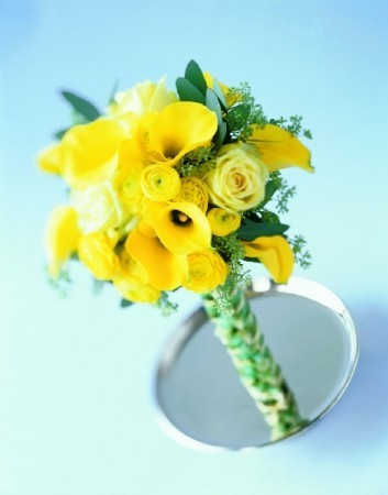 Handtied wedding bouquet with yellow roses tucked in and around yellow 