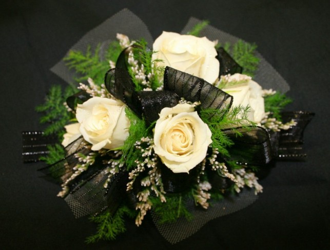 This unique white rose wedding bouquet was created using sheer black ribbon