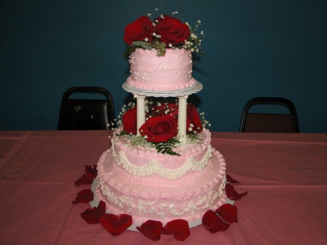 This pink wedding cake is amazing It is tediously decorated with tiny white
