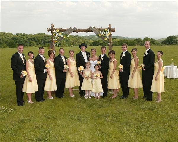  theme the groomsmen are wearing classic black tuxedos with light yellow 