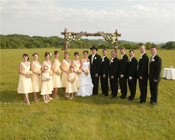 At this outdoor wedding near Blue Springs Missouri the wedding party stands