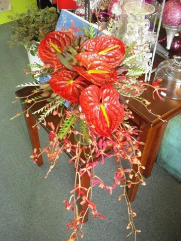 The fiery red tropical bridal bouquet in this photo was created using