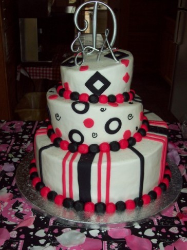 This three tier wedding cake features black white and hot pink accents in a