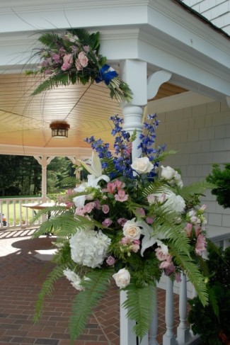 This beautiful flower arrangement decorates a gazebo at an outdoor wedding