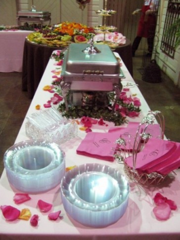 This romantic pink themed wedding reception table is accented with pink rose