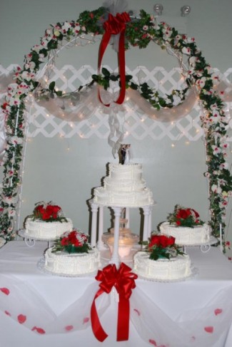 Beautiful red and white themed wedding cake with fountain at aLexington