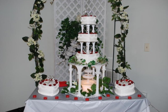 Here is a beautiful red and white themed wedding cake with fountain at a 