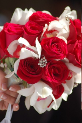 A Stunning Wedding Flower Bouquet Featuring Red Roses and White Cymbidium 