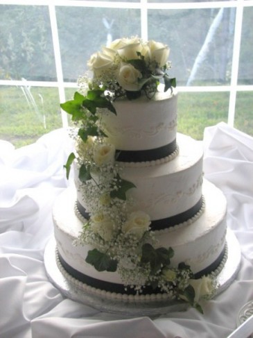  White wedding cake with floral topper 