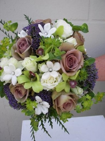 This wedding bouquet has been made in shades of purple lavender and white 