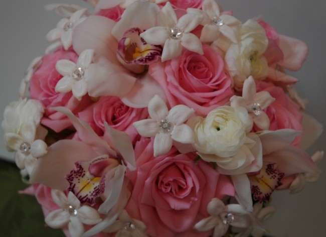 This light pink and ivory wedding bouquet is created with white cymbidium 