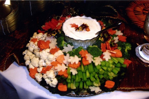 Vegetables and vegetable dip form a colorful fall food centerpiece for this
