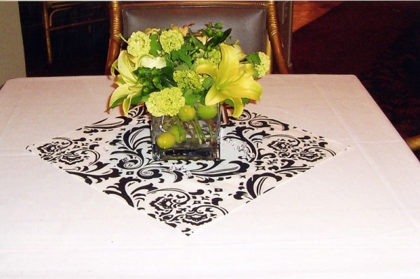 The black and white placemat is a stark contrast to the lemoncolored lilies 