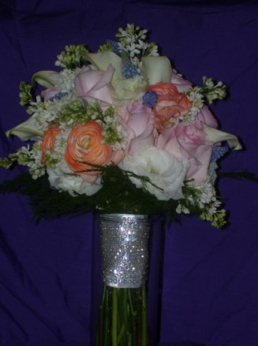  pink roses orange ranunculuswhite lilac and grape hyacinuthus in a 