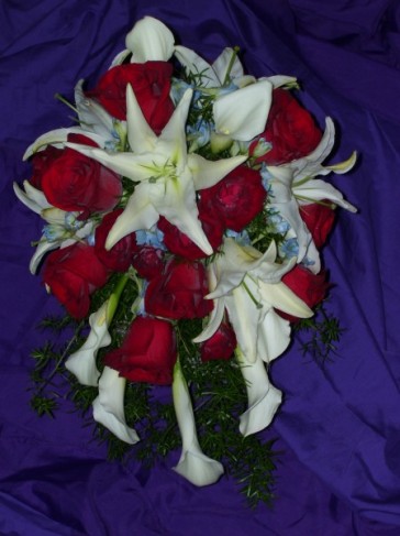 This red and white bridal bouquet is designed with white stargazers