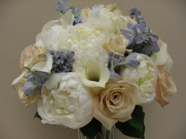 This ivory and purple wedding bouquet is filled with peonies and sahara 
