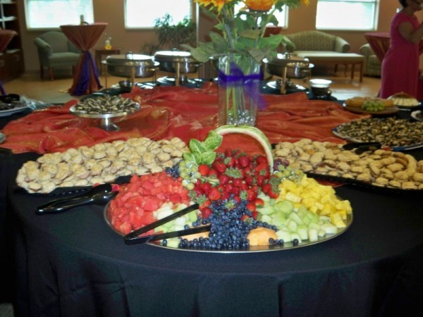 This wedding reception food table is elaborately set with delicious foods