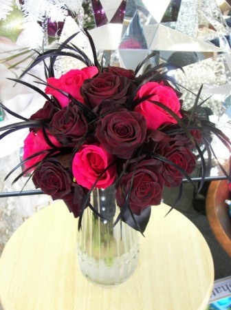 Fuchsia Black Bacarra Roses and Feathers This unique floral centerpiece is