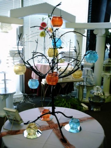 Pictures hanging from this tree make a great centerpiece for wedding 
