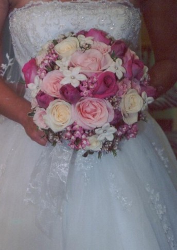 This gorgeous bridal bouquet is filled with pink and ivory flowers