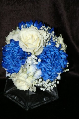 This beautiful bridal bouquet was created with blue mums white roses blue