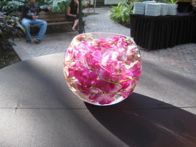 This gorgeous floral centerpiece shows light pink flowers floating in a 