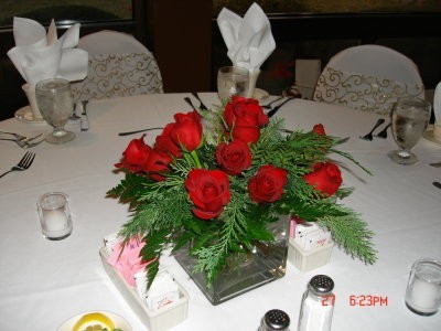 This red rose centerpiece is a bright contrast to the white linen of the