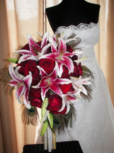 Stargazer lilies create a bright pop of color next to red roses