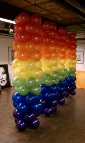 This photo shows off a rainbow balloon column decoration for an event