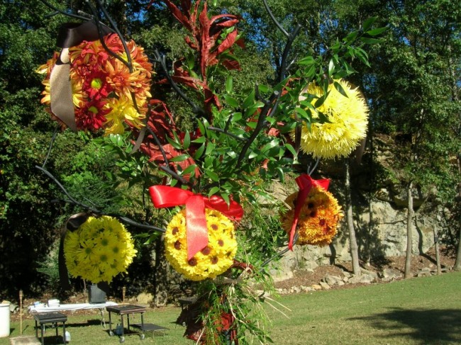 Made from daisies in shades of yellow orange and red these reception 